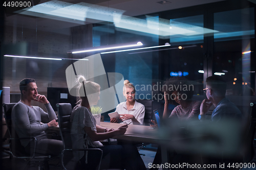 Image of Multiethnic startup business team in night office