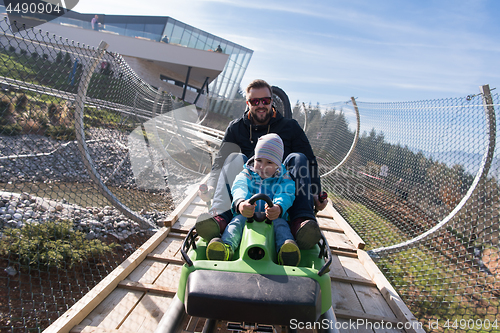 Image of father and son enjoys driving on alpine coaster