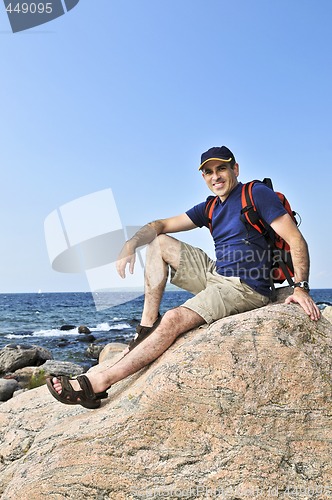 Image of Hiker sitting on a rock