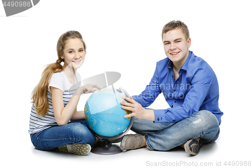 Image of Teen boy and girl with earth globe