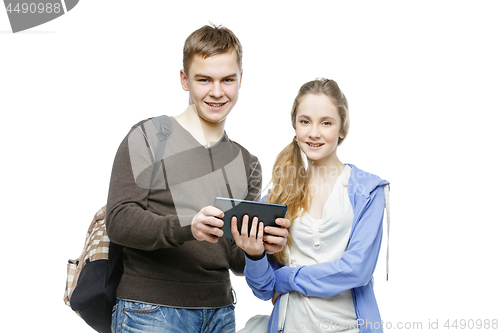 Image of Teen boy and girl standing with mobile phones