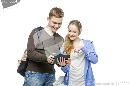 Image of Teen boy and girl standing with mobile phones