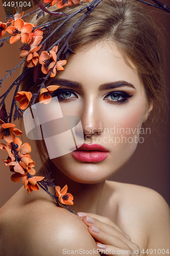 Image of Beautiful girl with sakura branch