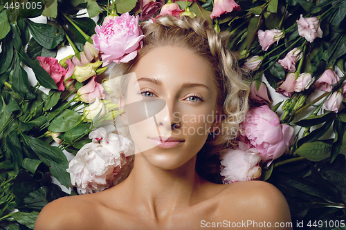 Image of Beautiful girl lying in flowers