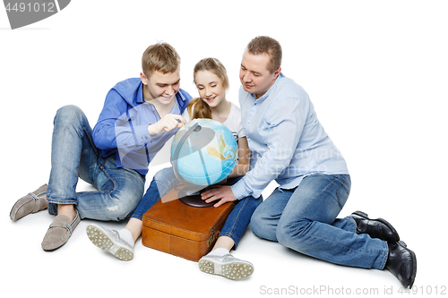 Image of father with children looking at earth globe