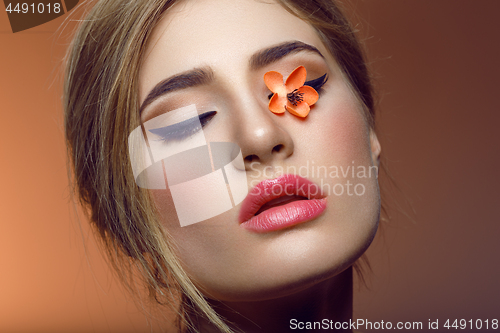 Image of Beautiful girl with sakura branch