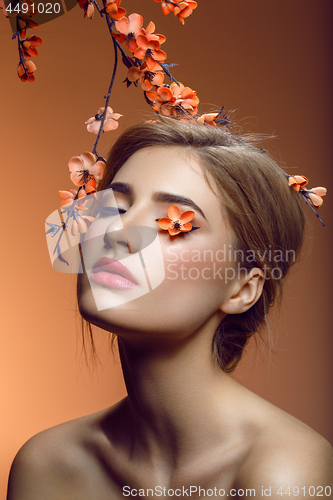 Image of Beautiful girl with sakura branch