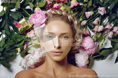 Image of Beautiful girl lying in flowers