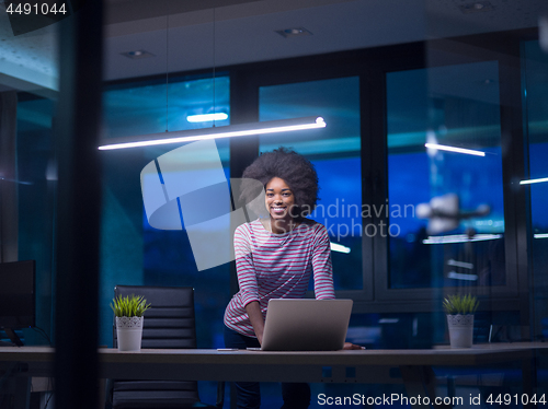 Image of black businesswoman using a laptop in startup office