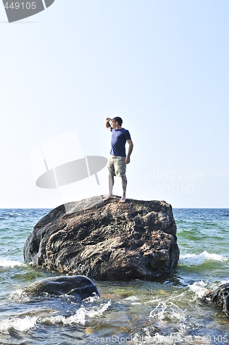 Image of Man stranded on a rock in ocean