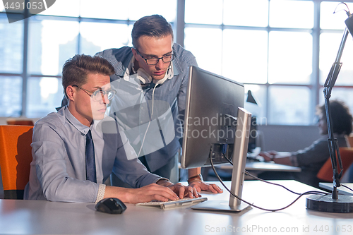 Image of Two Business People Working With computer in office