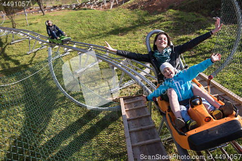 Image of mother and son enjoys driving on alpine coaster