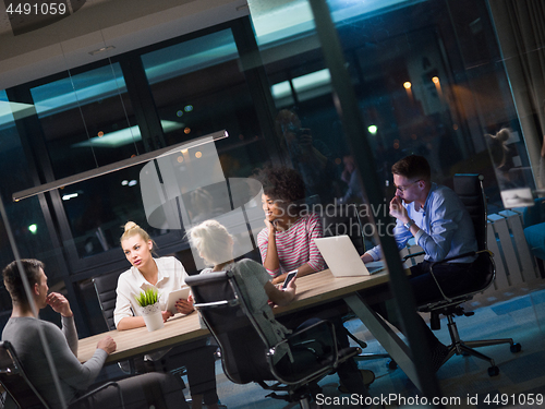 Image of Multiethnic startup business team in night office