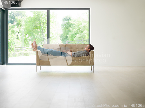 Image of Man using laptop in living room