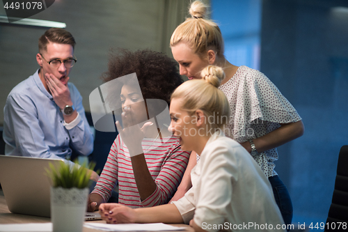 Image of Multiethnic startup business team in night office