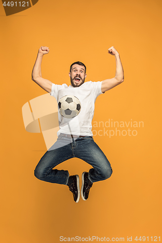 Image of The young man as soccer football player kicking the ball at studio