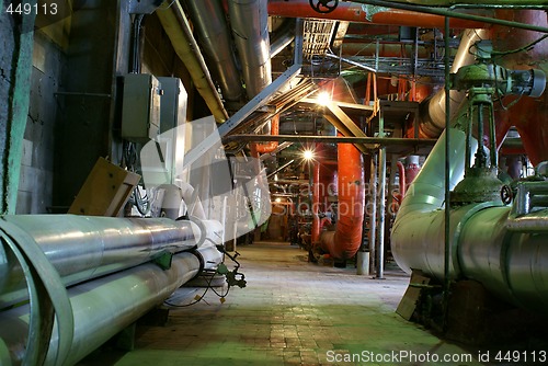 Image of Pipes, tubes, machinery and steam turbine at a power plant