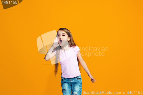 Image of Isolated on orange young casual teen girl shouting at studio
