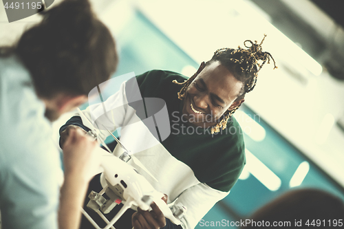 Image of multiethnic business team learning about drone technology