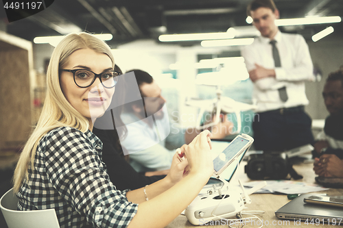 Image of blonde business woman learning about drone technology