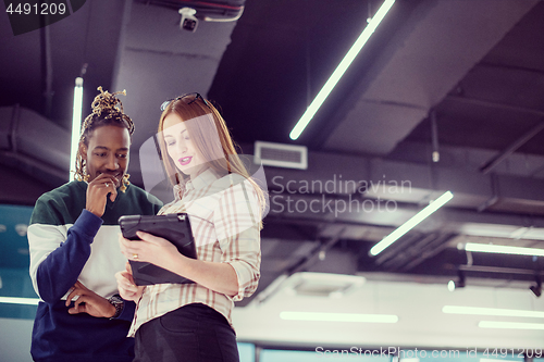 Image of multiethnic business couple using a tablet computer