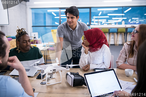 Image of multiethnic business team learning about drone technology