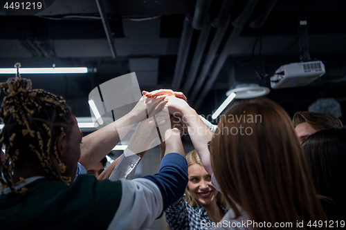 Image of multiethnic Group of young business people celebrating success