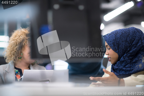 Image of black muslim female software developer at work