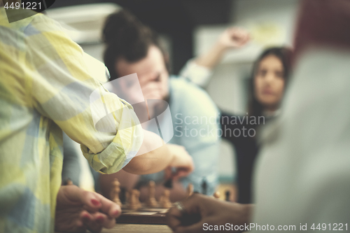 Image of multiethnic group of business people playing chess