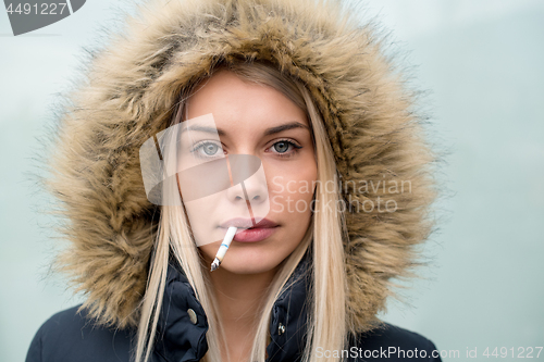 Image of portrait of young blonde girl with cigarette in the mouth