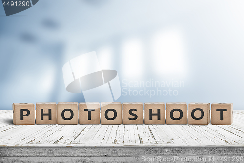 Image of Photoshoot word sign on a wooden desk