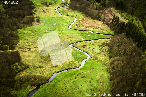 Image of Small river going through a green area with fields