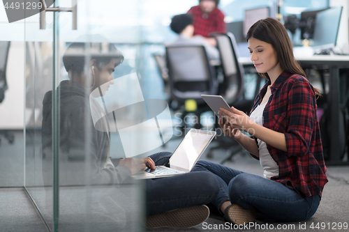 Image of software developers couple working on the floor