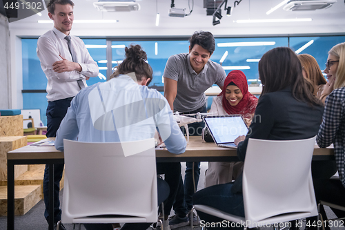 Image of multiethnic business team learning about drone technology