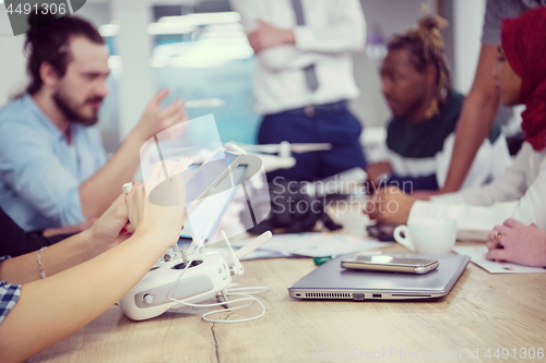 Image of multiethnic business team learning about drone technology