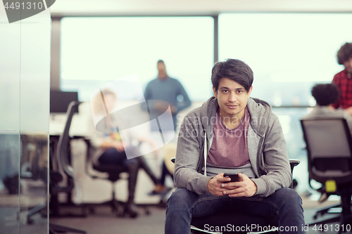 Image of software developer using mobile phone