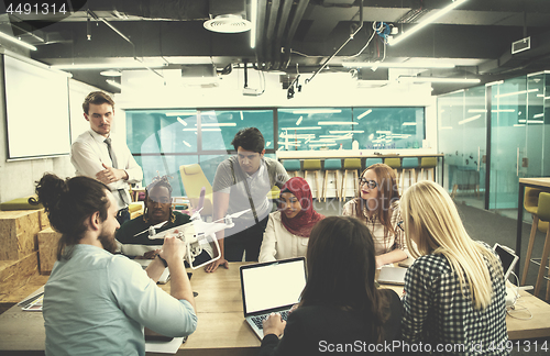 Image of multiethnic business team learning about drone technology