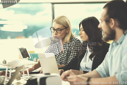 Image of multiethnic business team learning about drone technology