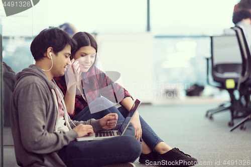 Image of software developers couple working on the floor