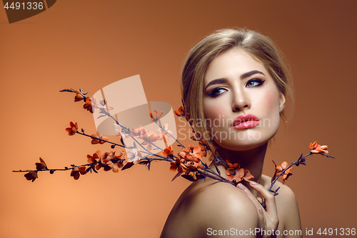 Image of Beautiful girl with sakura branch