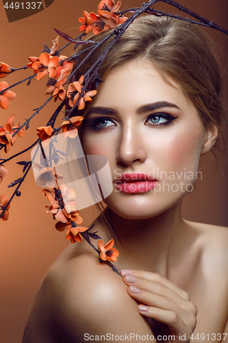 Image of Beautiful girl with sakura branch