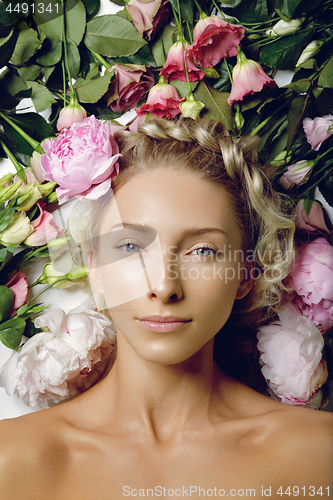 Image of Beautiful girl lying in flowers