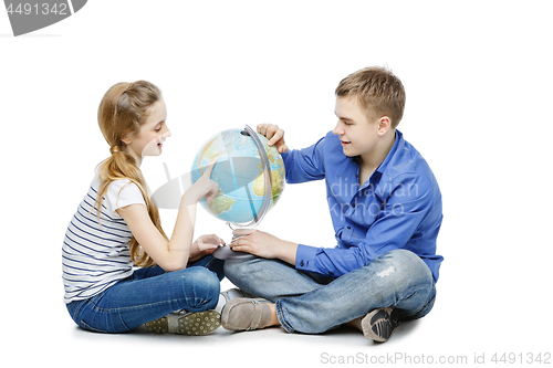 Image of Teen boy and girl with earth globe