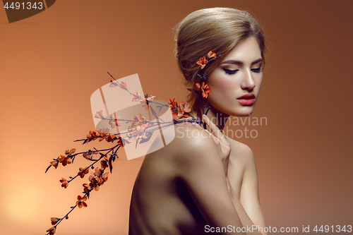 Image of Beautiful girl with sakura branch