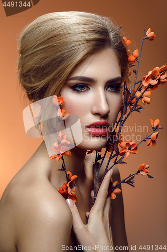 Image of Beautiful girl with sakura branch