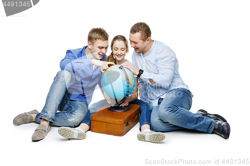 Image of father with children looking at earth globe