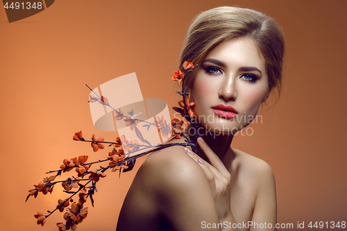 Image of Beautiful girl with sakura branch