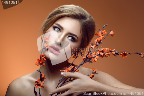 Image of Beautiful girl with sakura branch