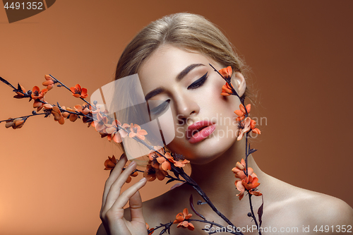 Image of Beautiful girl with sakura branch