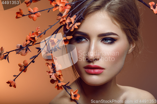 Image of Beautiful girl with sakura branch